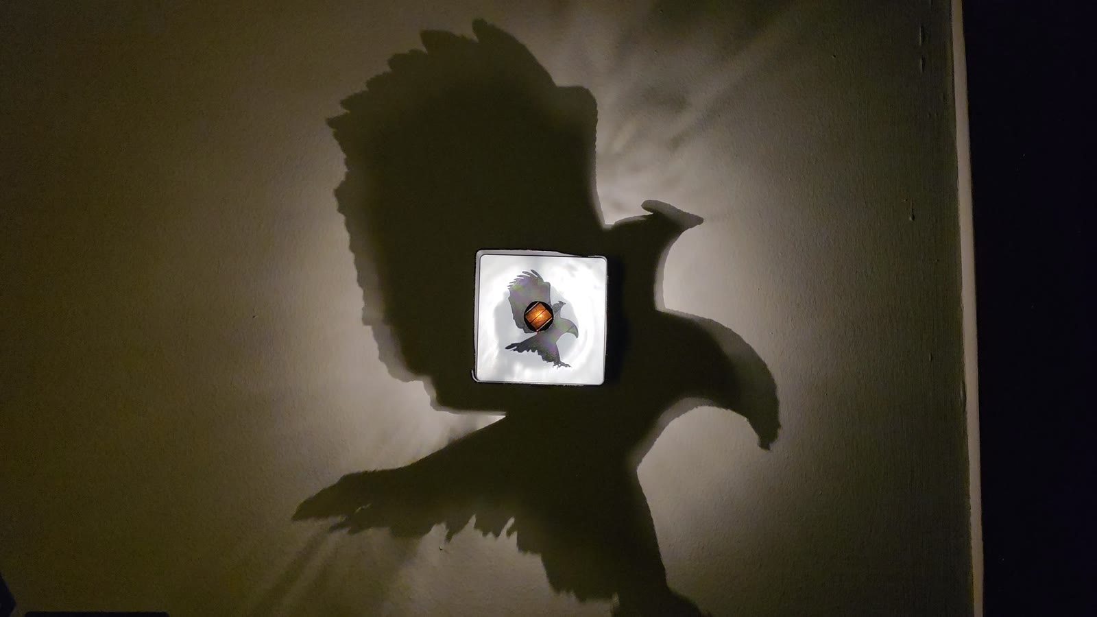 Light cast on a wall by the physical eagle prototype